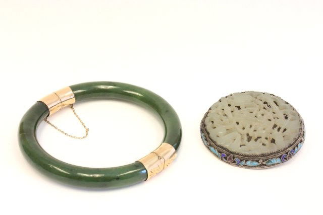 2 pieces jade jewelry: 1- Round jade, silver & enameled pin. 1- Green jade bracelet with yellow gold clasp & design, crack in jade. From a Montclair estate. Please read our terms of sale.