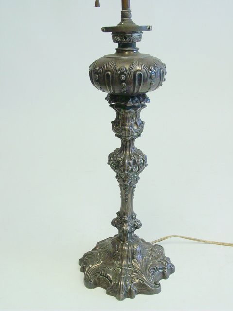 19th c. sterling silver oil lamp stamped: Electrified, scroll design. Approx. 19" H to base of front. Please read our terms of sale.