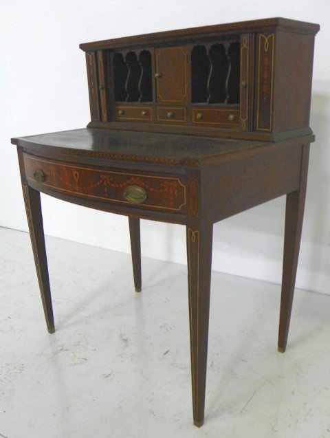 Inlaid Edwardian tambor writing desk: Mahogany, bell flower & inlaid drapery design, leather insert missing. Approx. 21" D x 30" W x 39" H. From a Port Monmouth, NJ estate. Please read our terms of sale.