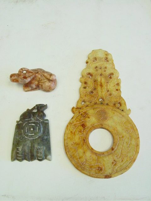 3 pieces Chinese carved stone: Including: 1- Yellow & brown jade disc, approx. 8" x 4". 1- Soapstone "Bull", approx. 1" x 2.5" L. 1- Green jade "Animal" on base, approx. 3". Please read our terms of sale.