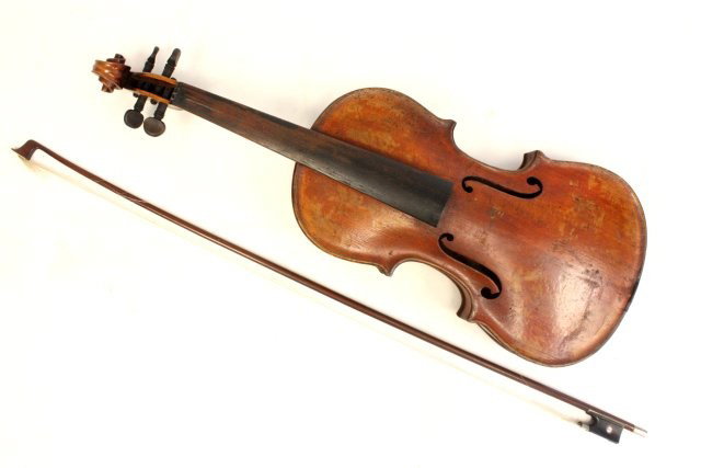 Violin with interior label with bow and case: Label reads Joseph Guarnerius Fecit Cremonae Anno 1735 1HS. Bow not signed, missing several pieces and strings. Approx. 23" L.