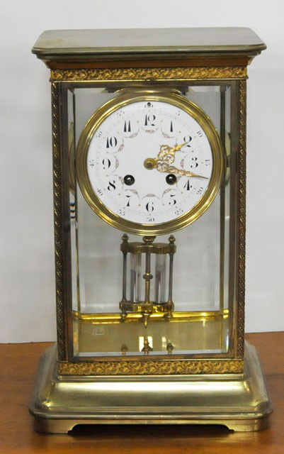 Tiffany & Co. bronze mantle clock: Bevelled glass sided with mercury pendulum. Approx. 13.75"H x 7.5"W.