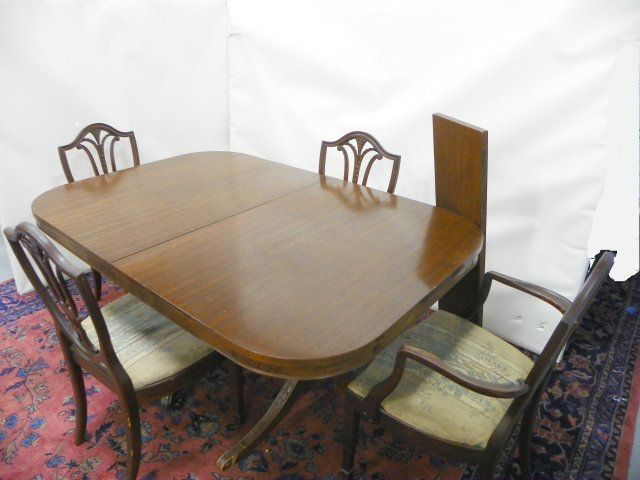 Mahogany dining room table & chairs: Dining room table has double pedestal and one leaf & 4 chairs. Approx. 44" W x 64" L.