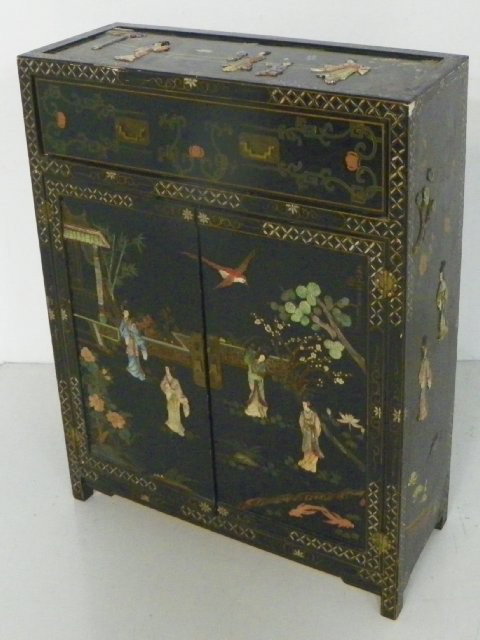 Chinoiserie & soapstone Chinese cabinet: Paint decorated, 2 door, with figures depicting "Daily Life", some paint loss. Approx. 3' W x 14" D x 44" H.