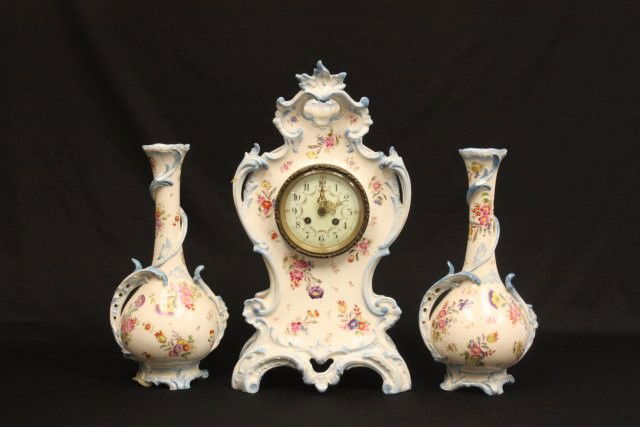 19th c. 3 piece handpainted porcelain clock set: "Floral", missing pendulum, vases marked Royal Bonn, vases are as is condition. Clock approx. 18.25" H, matching vases 13" H.