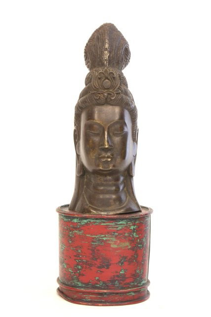Bronze "Buddha Head": Mounted on red tole base. Head approx. 12.5" H. From the estate of an Upper West Side, NYC gentleman.