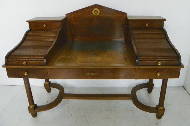 Unusual mahogany desk with S roll up sides: Leather top, middle pencil inlay, bronze mounted. Approx. 5' W x 42" H x 31.5" D. Please read our terms of sale.
