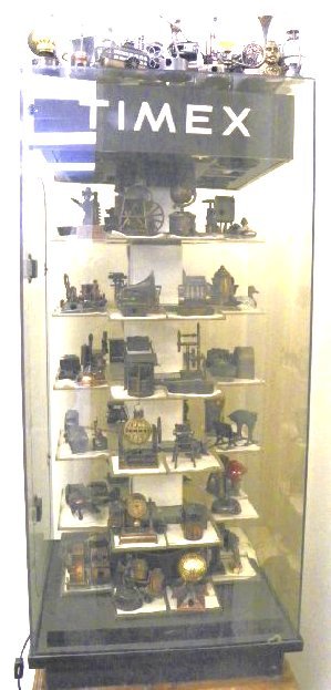 Timex cabinet with over 100 pencil sharpeners: Collection of 100 pencil sharpeners. Display cabinet lights & spins, missing key. Please read our terms of sale.