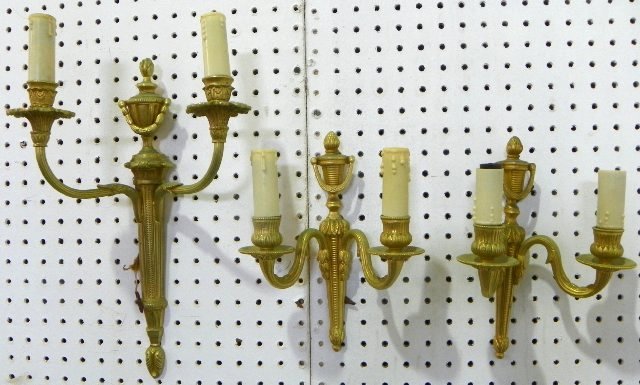 Lot of 3 bronze sconces: 1- Matched pair. 1- Odd sconce. Approx. 10.25" x 8.5" & 15.5" x 11". Please read our terms of sale.
