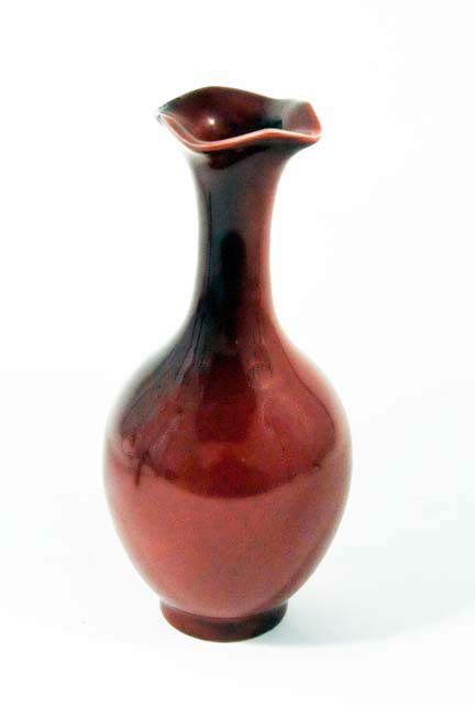 Chicken blood Chinese porcelain bud vase: Ruffled top, with Dao Guang mark, small flakes on top. Approx. 9" H. Please read our terms of sale.