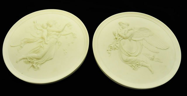 Pair figural parian Neo-Classical plaques: Circular, signed on back. Approx. 11" Diam.