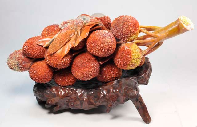 Soapstone carved: "Branch of Fruit with Locust Bug on top". Approx. 12" W x 5" H.
