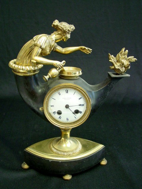 Brass & black "Aladdin & Flames" clock: Charles Dupont, Chaux De Ford on the face, French Empire, early 19th c. Approx. 15.25" H x 11" W. Partial contents of a North Plainfield, NJ mansion.