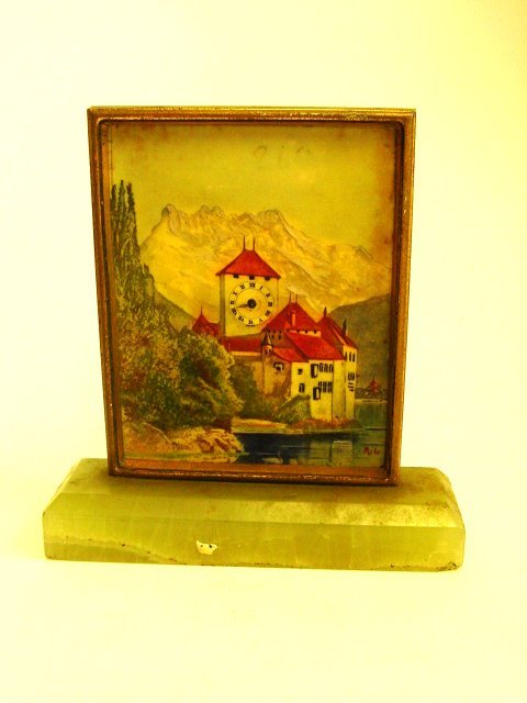 Swiss miniature desk clock.: By Solomax Watch Co. Early 20th c., on onyx base with "Swiss Mountain Scene". Missing glass. Approx. 4" H x 3.5" W