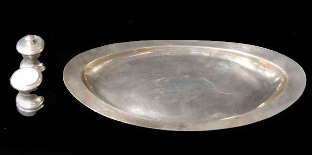 Group lot of Tiffany sterling silver pieces: 1-12.5" x 6.5" Tiffany sterling silver oval bread tray. 1-2" H Pair Tiffany salt & pepper shakers. Approx. 17.34 ozt, pepper has wood inside. From a Sutton Place, NYC estate.