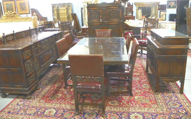 Carved 12 piece oak refractory dining room set: Jacobean style, 6 side chairs with leather seats, 2 arm chairs, server, buffet, & silver chest, all matching, fabulous quality, custom made glass tops.
