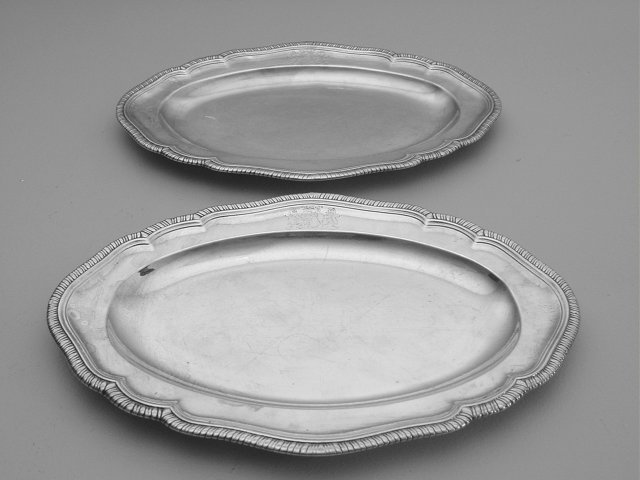 Pair sterling silver hand chased trays: Approx. 26.9 troy oz. With coat of arms, English hallmarks, possibly Thomas Wallis & Jonathan Hayne, 1852. Approx. 14" x 9 7/8". From the collection of Rigo Cardenas "Mr. Fortuny", a well known textil