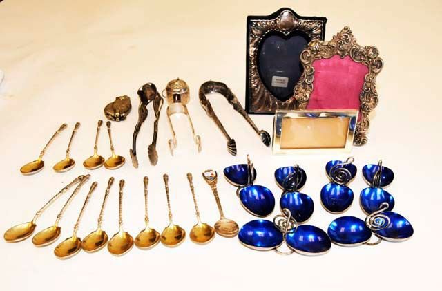 Group lot 27 pcs. sterling & European silver: Includes: 12 hoofed demitasse spoons. 2 figural tongs. 1 hand hammered tong. 3 sterling silver frames. 6 European enameled salt cellars. 1 souvenir spoon. 1 cat pendant. 1 miniature "artcraft" teapot.