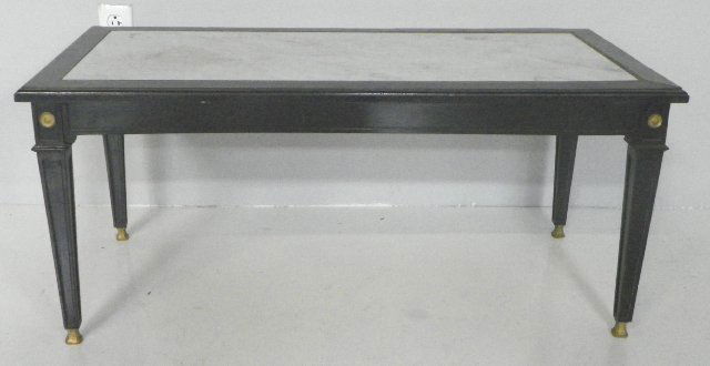 Louis XVI style marble top coffee table: Stamped Jansen. Bronze mounted, black lacquered with white marble top. Approx. 17 1/2"H X 38 1/2" W X 19 3/4" D. Please read our terms of sale.