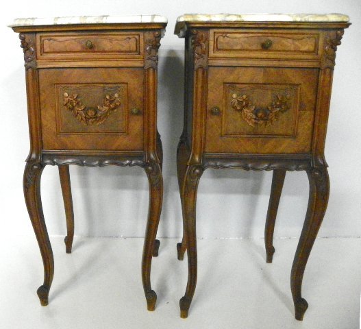 Pair marble top & walnut nightstands: 1 door, 1 drawer, carved with "Flowers" on doors, 1 marble cracked Approx. 33.25" H x 15.75" W x 16" D. Please read our terms of sale.