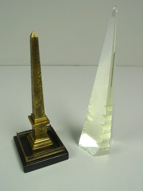 2 obelisks: 1- Bronze with "Egyptian Hieroglyphics" on marble base, approx. 10.5" H. 1- Crystal, approx. 12" H. From the estate of prominent antique collector from Brooklyn Heights, NY. Please read our terms of s