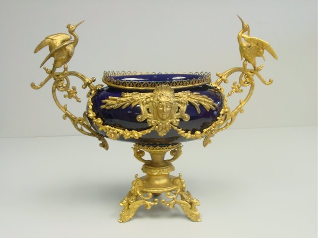 19th c. gilt metal figural porcelain centerpiece: Approx. 22" W x 18.25" H. Please read our terms of sale.