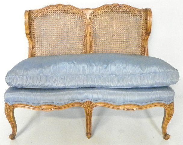 Country French walnut caneback settee: Blue down upholstered slip seat. Approx. 36" W x 18" to seat x 30.5" to back. From a Ft. Lee, NJ estate. Please read our terms of sale.