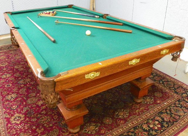 Oak Victorian pool table "Monarch": The Brunswick, Blake & Collander Co., with cue, pool sticks & balls, professional size, mother of pearl inlays. Approx. 109" x 59" x 34.25" H. From the collection of a prominent Westfield, NJ Doctor.