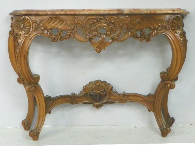 Marble top carved walnut console table: Approx. 50" W x 17" D x 33.5" H. From the Riverdale, NY estate of Nell Martinis. Marble has been repaired. Please read our terms of sale.