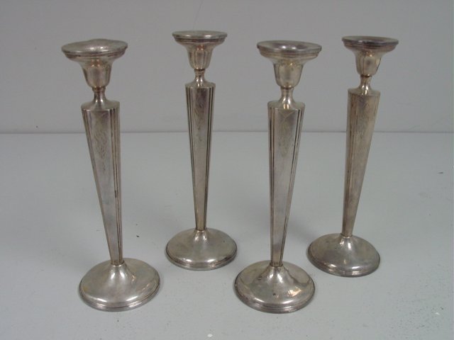 Set of 4 sterling silver weighted candlesticks: Approx. 10" H. From the Riverdale, NY estate of Nell Martinis. Please read our terms of sale.