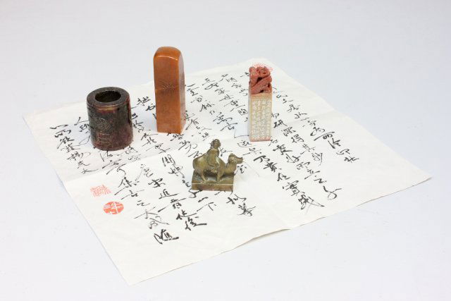 Group lot of 4 Chinese pieces: Including: 2- Stone seals. 1- Jade ring. 1- Bronze seal depicting "Man on a Camel" with calligraphy describing the seal is Tian Hung stone in artist's own handwriting. Please read our terms of sale.