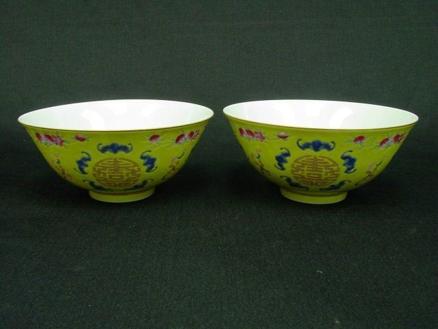 Pair Xuantong Famille Rose bowls: Enameled and gilt to the exterior with auspicious BATS, FRUITING PEACHES AND SHOU characters, all reserved on a bright yellow ground, XUANTONG six-character blue mark to the white glazed base. It is r