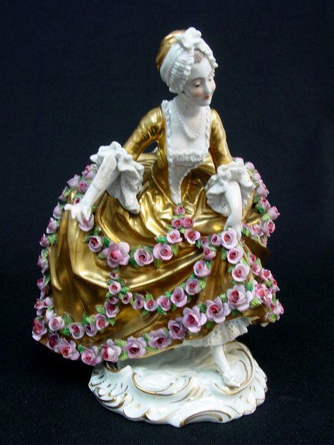 Royal Vienna porcelain figure "Woman": In rose colored dress. Approx. 7.75" H. Minor loss to flowers. Please read our terms of sale.