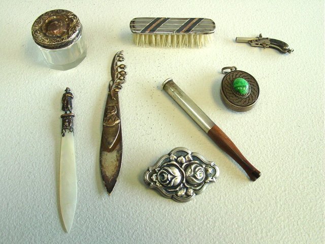 Group lot of 8 pieces of silver: Including: Locket with turquoise stone, gun drop, mother of pearl & silver letter opener, book mark depicting "Napoleon", miniature brush & box, pin & wood & silver cigarette holder.