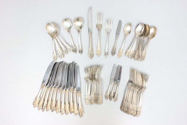 Set of sterling silverware Wallace Grand Baroque: Including: 13 luncheon forks, 6 bullions(1 dented), 13 dinner forks, 12 knives (approx 9" L), 4 butter knives, 12 teaspoons, 1 serving spoon. 61 pieces in total.