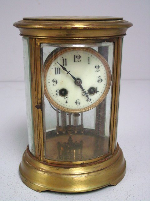 Oval crystal & brass regulator clock: Stamped "Made in France", with pendulum. Approx. 9" H.