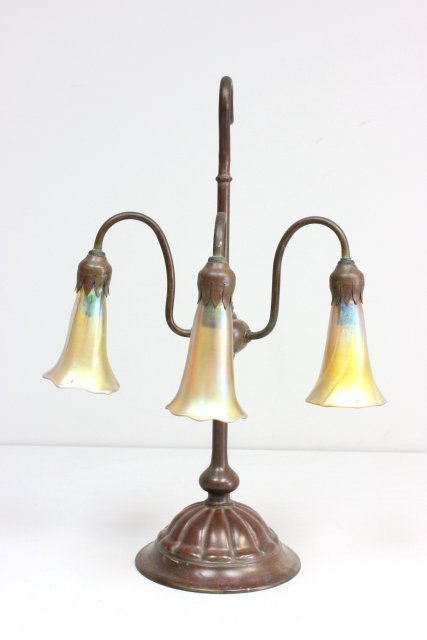 Signed Tiffany Studios triple lily light desk lamp: Shades marked LCT, bottom of lamp base marked Tiffany Studios New York 324. Approx. 19" H x 10 1/2" W., shades 4 5/8" L.