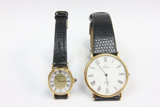 2 watches: 1- 14kt Concord Swiss quartz mens watch with leather band. 1- Torneau quartz ladies watch with faux lizard band.