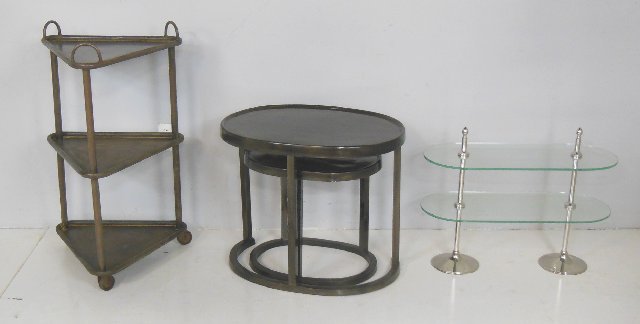 Group lot of tables: 1- Triangular metal table on wheels, approx. 35" H. 2- Nesting oval tables, approx. 22" x 26" x 19". 1- 2 tier chrome & glass table.