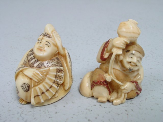 2 Katabori Netsuke carved bone figures: Seated Man with Fan & "Seated Man Pouring Water on his Head". Artist signed. Approx. 2" & 1.5" H.