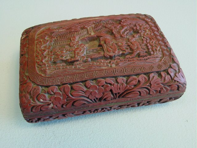 Early Chinese cinnabar box: Depicting "Old Men Playing Chess", with Qian Long mark on base. Approx. 5.75" L x 4.5" W x 1.75" H.