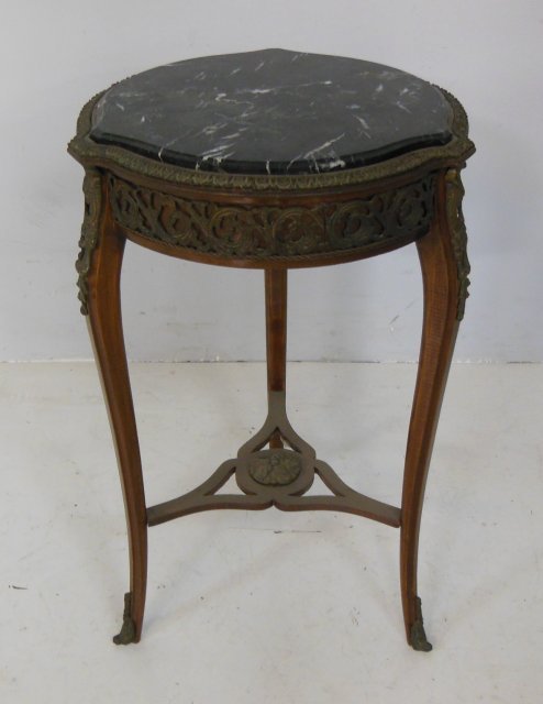 French mounted bronze ormulu marble top table: With black marble top. Approx. 29" H. X 18" Diam.