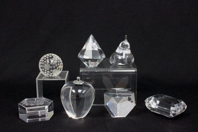 7 Crystal paperweights: Including Steuben "Apple," Tiffany & Co. "Cube," Tiffany & Co. "Golf Ball," Baccarat "Pentagon," 1 pear, 1 diamond pyramid, 1 diamond shape(chipped).