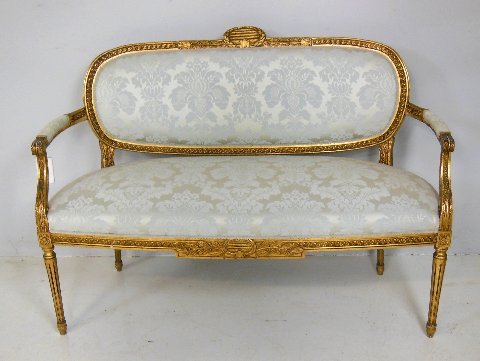 Early 20thc. Louis XVI style French loveseat: Ivory brocade upholstery and spindle legs. Approx. 38" H. X 53" W. X 20" D (seat).