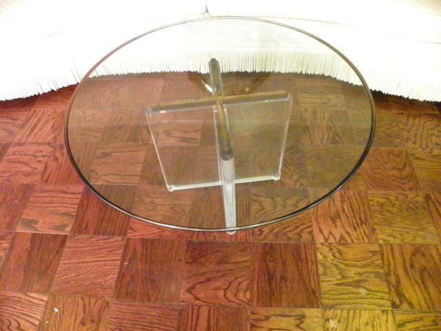 Round glass top modern coffee table: With lucite base. Approx. 18" x 36" Diam.