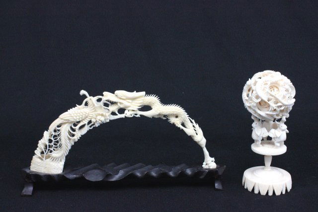 2 Chinese carved bone pieces: Including: "Bridge" on teakwood stand, depicting bird attacking a dragon, claw leg removable, approx. 6" H x 10" W. "3 Standing Elephants Holding a Magic Dragon Ball". From a Middletown, NJ collection