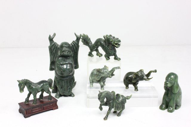 7 green Chinese jade sculptures: Including: 1- "Seated Dog", approx. 3.5". 1- "Dragon", approx. 2.5" H. 1- "Happy Buddha", approx. 6" H. 2- "Elephants", 1 as is (chipped ear), approx. 2" H. 2- "Horses", approx. 2" H. Various bases. F