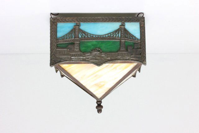 Slag glass hall light fixture: Depicting "The Brooklyn Bridge", blue, green & yellow slag glass, acorn finial. Approx. 8.5" W x 8.5" H.