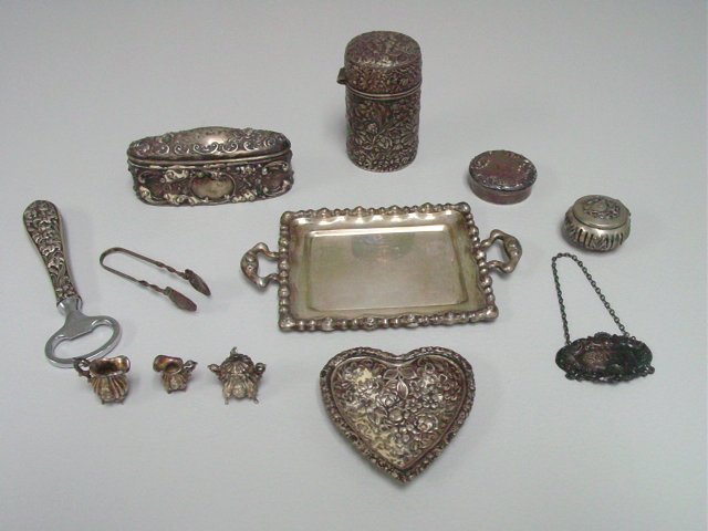 Group lot of 9 pieces sterling silver: Including: Miniature tray with sugar, creamer and pitcher. Repousse bottle opener. Oval box. Steiff heart dish. 800 pill box. Howard & Co. round pill box. Scotch tag. Gorham repousse cylandrical box.