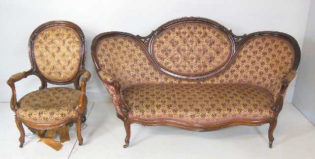 Victorian oval back walnut settee & chair: Damage to the left molding of the settee. Matching arm chair has falling bottom springs.